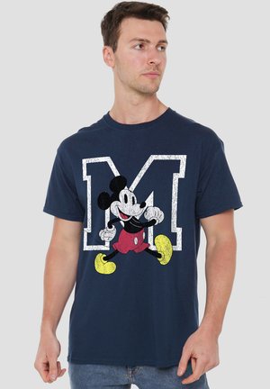 Navy blue cotton T-shirt featuring a graphic of a cartoon character in red shorts and yellow shoes, with a bold white letter "M" behind.