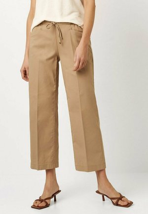Beige wide-leg trousers made of lightweight fabric, featuring a drawstring waist and two side pockets, with a smooth texture and clean lines.