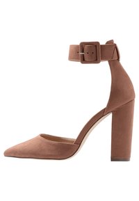 Brown suede high-heeled pump with a pointed toe and a thick block heel. Features an ankle strap with a square buckle.