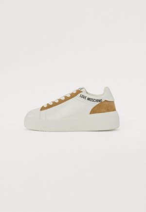 White leather sneakers with a tan suede accent, round toe, flat rubber sole, and "LOVE MOSCHINO" branding on the side.