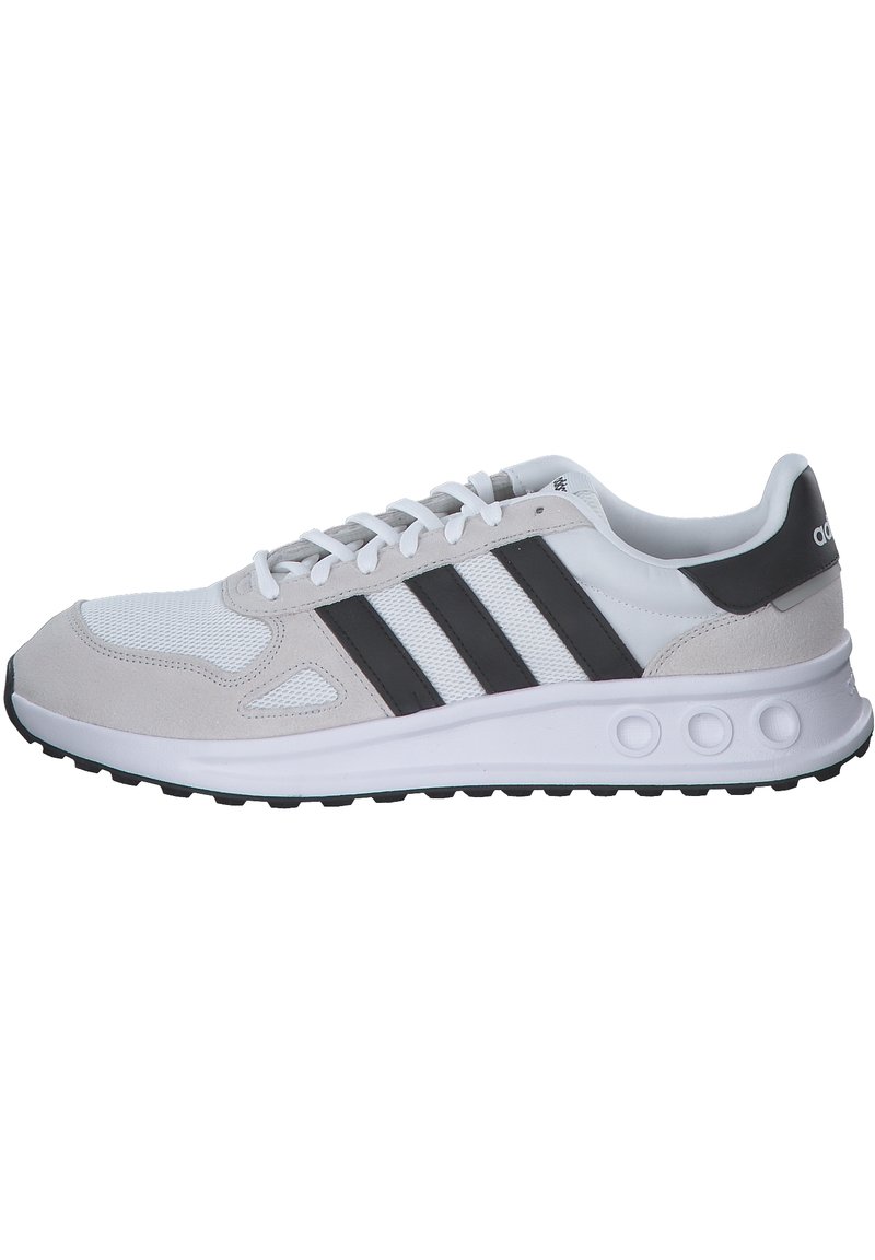 Gray and white athletic shoe featuring a mesh upper, suede accents, three black stripes, and a textured rubber sole with round cutouts.