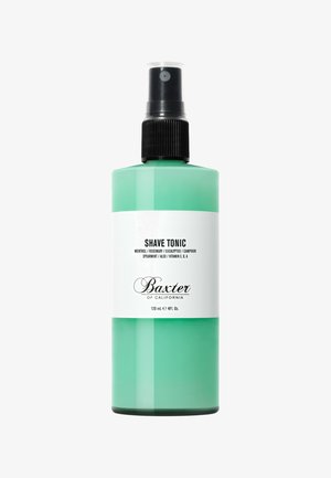 Groene plastic spuitfles met een zwarte pompnozzle. Witte label bevat de tekst "SHAVE TONIC" en productdetails. Bevat 120 mL.