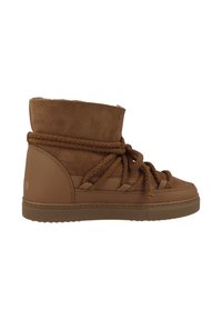 Botas de tobillo de ante marrón con una superficie texturizada, que cuentan con cordones de cuerda gruesos, un collar acolchado y una suela de goma para mayor agarre.