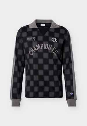 Mustade ja hallide ruutudega pikad varrukad spordisärk, halli kraega, rinnal tekst "CHAMPION F.C." ning Championi logo rinnal ja varrukakattel.