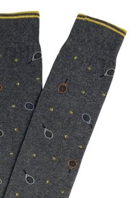 Calze grigie con un motivo ripetuto di racchette da tennis e palline nei toni del giallo, blu e arancione; orlo a coste giallo.