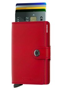 Cartera de cuero rojo con cierre a presión, que cuenta con un tarjetero donde se ven parcialmente varias tarjetas. Marca en el lateral. Textura suave.