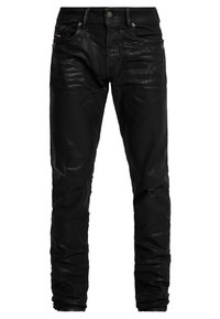 Svarta denimjeans med slim fit, som har en lätt glans, slitna detaljer och framfickor. Hållbart tyg med en mjuk yta.