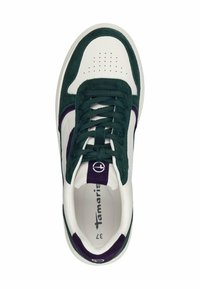 White sneaker with dark green suede accents. Features a round toe, padded tongue, and contrasting purple detailing on the logo and heel.