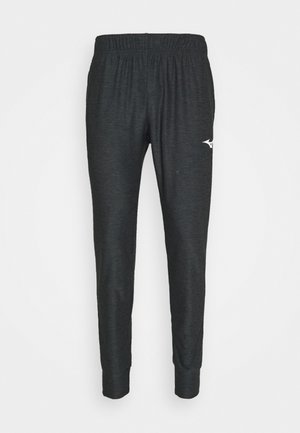 Pantalon de jogging gris foncé fuselé avec taille élastique et petit logo blanc sur la cuisse gauche sur fond uni.