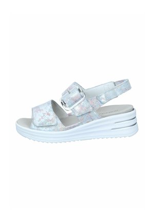Sandal with a shiny, iridescent strap, white cushioned sole, adjustable buckle, and open toe design. Flat platform with textured grip.