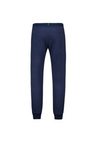 Marineblauwe joggingbroek van zacht materiaal, met een elastische tailleband en geribde manchetten. Eenvoudig ontwerp zonder zichtbare patronen of accenten.