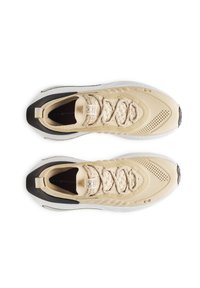 Beige athletic shoes with a textured mesh upper, black heel accents, and a white sole, featuring a lace closure and logo detailing.
