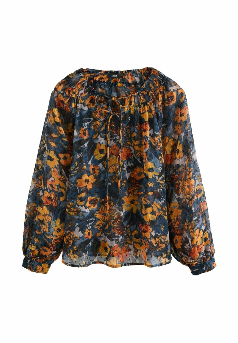 Blusa de tejido transparente con estampado floral, que presenta un fondo azul marino con flores naranjas y amarillas, mangas largas y escote fruncido.
