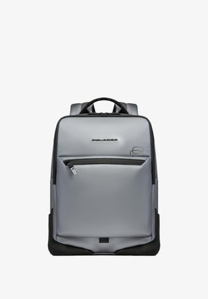 Gray rectangular backpack with front zip pocket, black accents, and top handle, featuring a "Piquadro" logo near the top center.