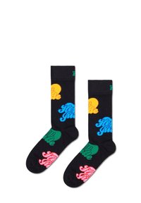 Chaussettes noires avec des motifs de texte colorés en orange, bleu, vert et rose. Poignets côtelés avec une texture douce et des accents ronds.