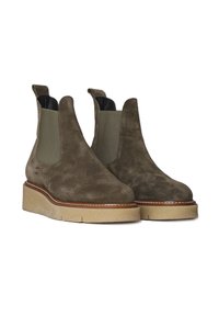 Bottines en daim marron avec des panneaux latéraux élastiques, bout rond et semelle chunky beige. Comprend un liseré contrastant autour de la semelle.