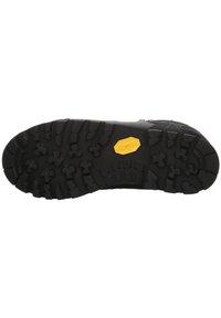 Svart gummisula med djupa mönster för bra grepp, med en gul Vibram-logotyp. Texturerad yta för bättre grepp och hållbarhet.
