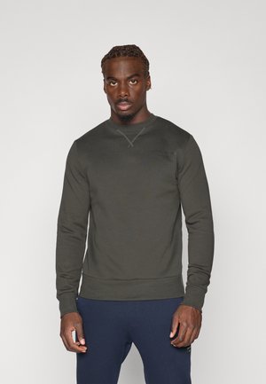 Dunkelgrüner Sweatshirt aus weichem Material mit langen Ärmeln, Rundhalsausschnitt und dezentem Branding auf der Brust. Slim Fit mit gerippten Bündchen und Saum.