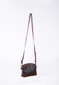 Brown leather crossbody bag with a zip closure, smooth and textured surfaces, an adjustable strap, and a subtle embossed design on top.