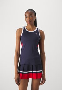 Navy tank top with white trim and red side accents, paired with a pleated skort featuring navy, white, and red horizontal stripes.