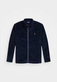 Tummansininen corduroy-tyylinen vetoketjullinen takki, jossa on kaulus, rintatasku, jossa on pieni vaaleanpunainen Polo Ralph Lauren -logo, pitkät hihat ja napilliset hihansuut.