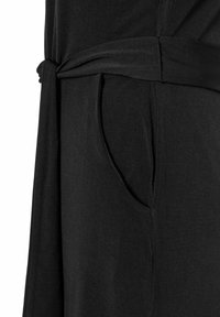 Zwart jurkje met een gestrikte taille, zachte stof en een zijzak met een nette naad. Het ontwerp is minimalistisch en gestructureerd.