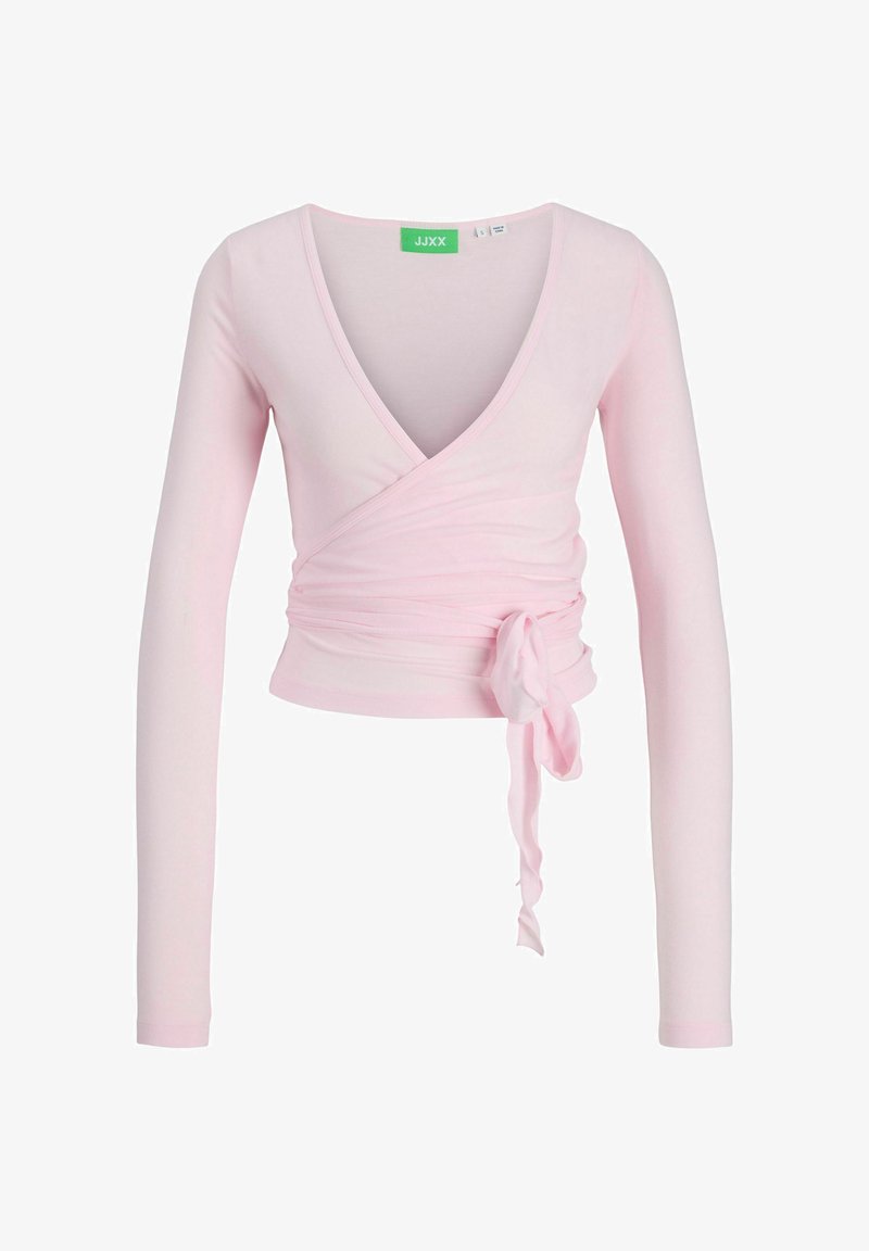 Lys rosa innpakningsbluse med dyp V-hals, lange ermer og knyte detaljer i midjen. Laget av myk, stretchy tekstil.