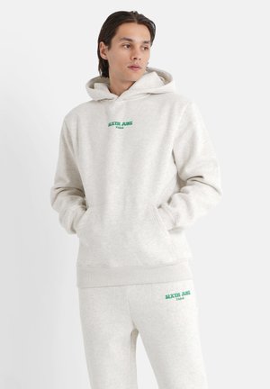 Gray hoodie and matching sweatpants made of soft fabric, featuring a green logo text "SIXTH JUNE PARIS" on the front and thigh.