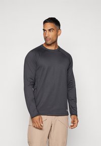 Langärmliges Sportshirt in Dunkelgrau, aus einem glatten, elastischen Material mit Raglanärmeln und Rundhalsausschnitt.