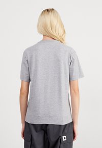 Gray cotton T-shirt with a round neckline and short sleeves. The back is plain with no logos or patterns, featuring a relaxed fit.