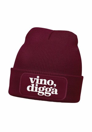 Burgundy knit beanie with a folded cuff featuring a rectangular patch; white text reading "vino, digga" on the front. Textured fabric.