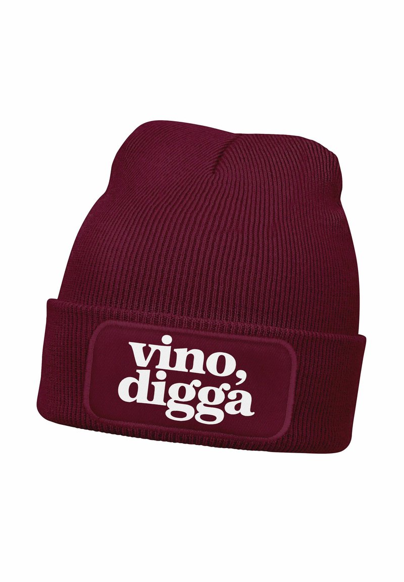 Burgundy knit beanie with a folded cuff featuring a rectangular patch; white text reading "vino, digga" on the front. Textured fabric.