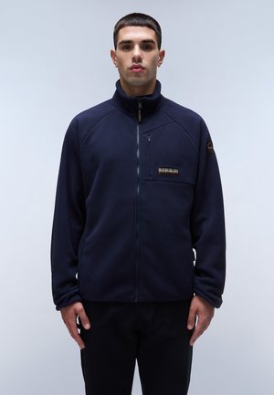 Navy fleece jacket with full zip, high collar, zippered chest pocket, and logo patch. Features raglan sleeves and smooth texture.