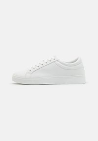 White sneakers with a smooth leather upper, rounded toe, flat sole, and minimalistic lace-up design. Perforated accents on the sides.