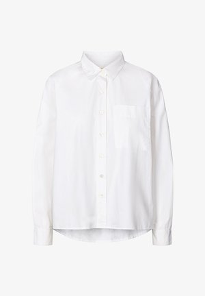 Balta krekla ar garām piedurknēm pogu aizdare, izgatavota no viegla auduma, ar klasisku apkakli, vienu krūšu kabatu un noapaļotu apakšmalu.