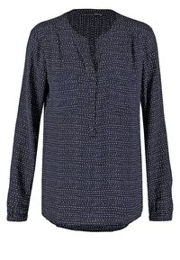 Blusa navy con maniche lunghe, collo rotondo, apertura centrale con bottoni e motivo a pois bianchi su un tessuto liscio. Vestibilità regolare.