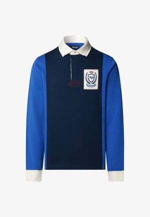 Koszulka rugby z długim rękawem, z granatowym paneliem centralnym, niebieskimi rękawami, białym kołnierzykiem i mankietami, oraz naszywką z logo z 1950 roku po lewej stronie klatki piersiowej.