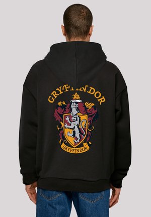 Black hooded sweatshirt featuring a Gryffindor crest in vibrant colors on the back, with a relaxed fit and soft texture.