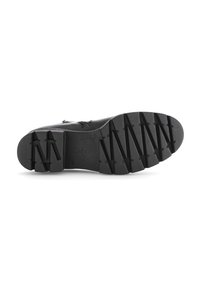 Semelle extérieure en caoutchouc noir avec un motif de prise texturé. Présente des éléments de traction en zigzag surélevés. Nom de la marque "Gabor" embossé sur le côté.