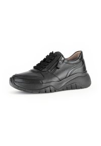 Black leather sneaker with textured upper, laces, and zip closure. Thick rubber sole with distinct tread pattern. Rounded toe design.