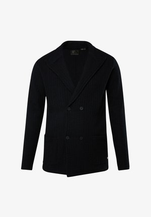 Navy sininen kaksirivinen bleiseri, joka on valmistettu teksturoidusta kankaasta, jossa on herringbone-kuvio, leveät läpät ja kaksi etutaskua.