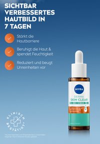 NIVEA Derma Skin Clear serum in a brown glass bottle, with a white dropper cap. Label features blue and green accents, detailing key ingredients.
