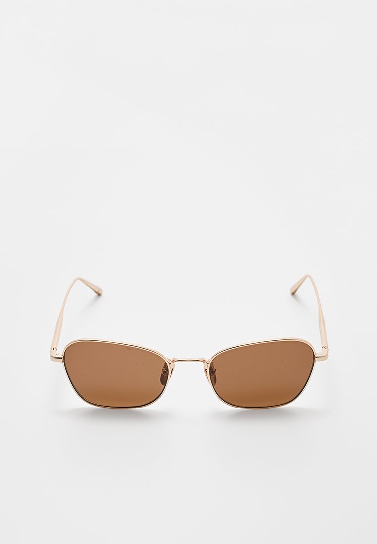 Brązowe okulary przeciwsłoneczne z elegancką, prostokątną oprawą, złotymi metalowymi akcentami i przyciemnionymi soczewkami. Zawiasy mają minimalistyczny design.