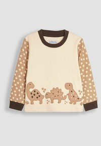 Chemise beige à manches longues avec des appliqués de dinosaures en brun. Les manches sont ornées d'un imprimé de petites traces de dinosaures. Col et poignets côtelés en brun.