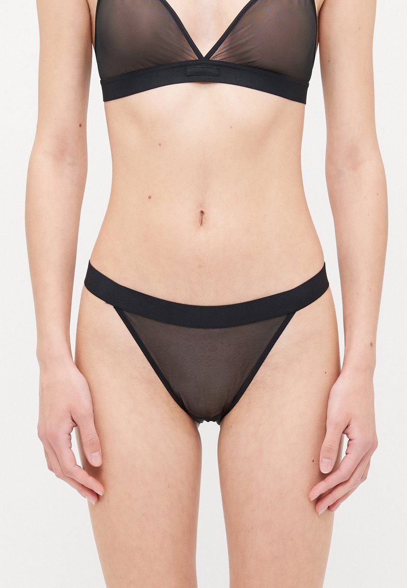 Black lingerie set featuring a sheer mesh bralette with a v-neckline and matching low-rise briefs, both with solid elastic bands.