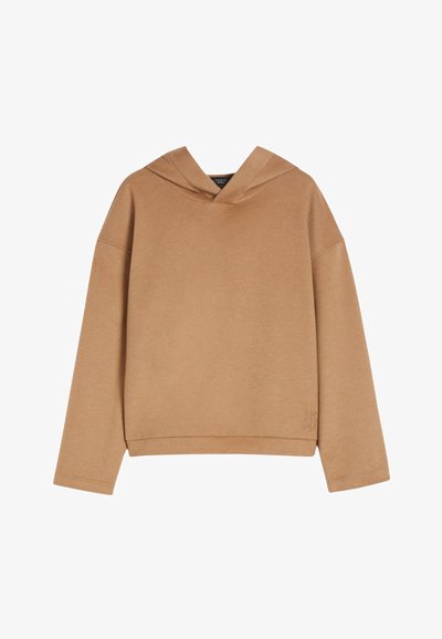 Beige oversized hettegenser med lange ermer, avslappet passform, og subtil logo-brodering nær bunnen på høyre side.