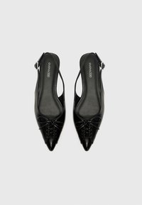 Black slingback shoes with pointed toes, leather material, featuring a lace-up detail and a smooth finish. Simple buckle closure at the heel.