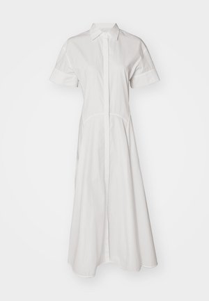 Rochie albă din bumbac, cu mâneci scurte, închidere cu nasturi în față și fustă evazată. Design simplu, fără modele sau accente.