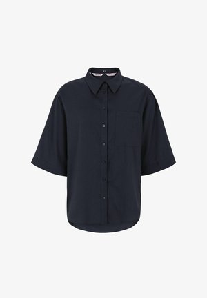 Teget košulja s dugmadima, ovratnikom, kratkim rukavima i lijevim džepom na prsima. Tkanina izgleda glatko s blagim sjajem.