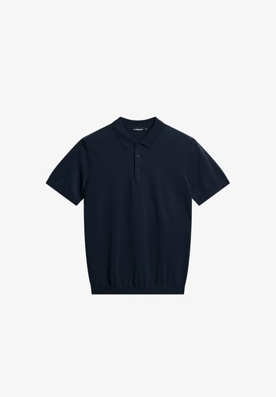 Polo de manga corta azul marino hecho de algodón suave, con tapeta de dos botones, cuello acanalado y cintura ajustada.